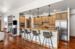 This stunning kitchen boasts a modern design with sleek cabinetry and a spacious island, perfect for entertaining.