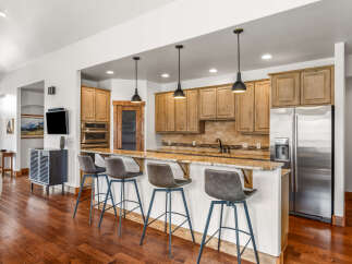 This stunning kitchen boasts a modern design with sleek cabinetry and a spacious island, perfect for entertaining.