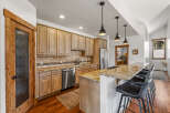 This stunning kitchen boasts a beautiful granite countertop and a stylish breakfast bar, perfect for entertaining.