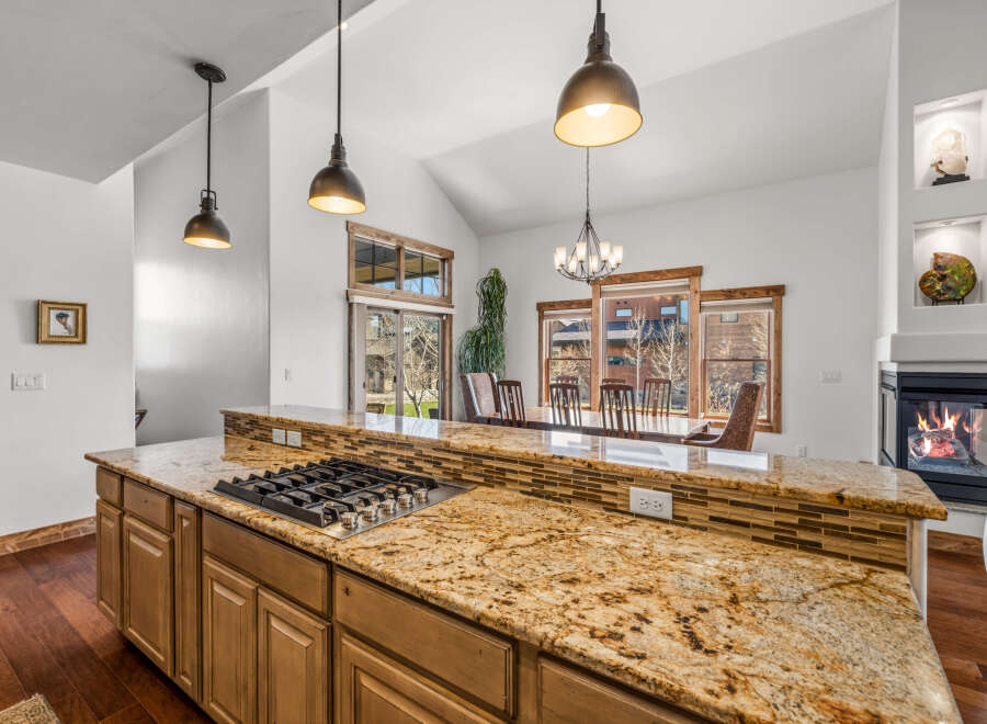 This stunning kitchen boasts a beautiful granite countertop, perfect for meal preparation and entertaining.
