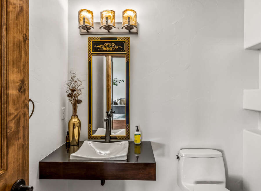 This stunning bathroom features a modern design with a sleek floating vanity and a stylish vessel sink.