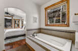This luxurious bathroom features a pristine white bathtub, perfect for relaxation.