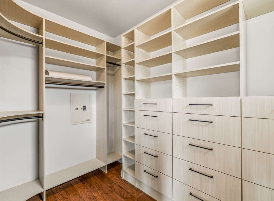 This custom-built closet offers ample storage and organization solutions.