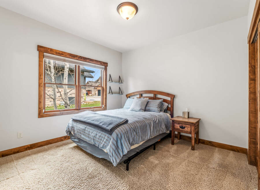 This cozy bedroom features a comfortable bed with a stylish headboard, perfect for a relaxing retreat.