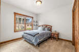 This cozy bedroom features a comfortable bed with a stylish headboard, perfect for a relaxing retreat.