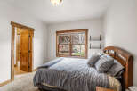 This cozy bedroom features a comfortable bed with soft pillows and a stylish wooden headboard.