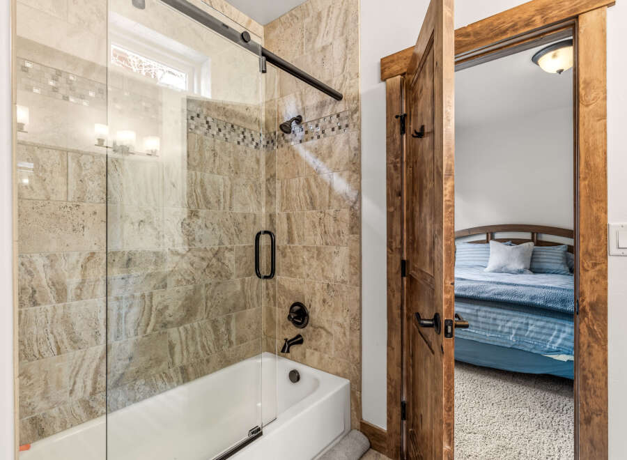 Step into a beautifully designed bathroom featuring a modern shower with a glass door and elegant tile work.