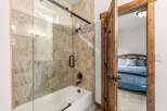 Step into a beautifully designed bathroom featuring a modern shower with a glass door and elegant tile work.
