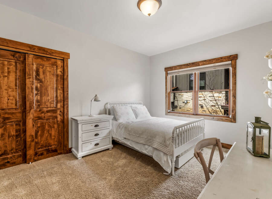 This charming bedroom features a cozy bed, perfect for a relaxing retreat.