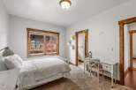 This charming bedroom features a cozy ambiance with its soft, neutral color palette and inviting textures.