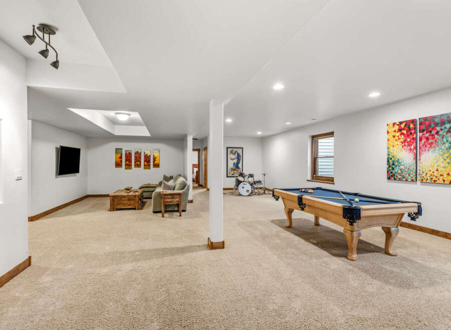 This spacious basement offers a perfect blend of relaxation and entertainment.