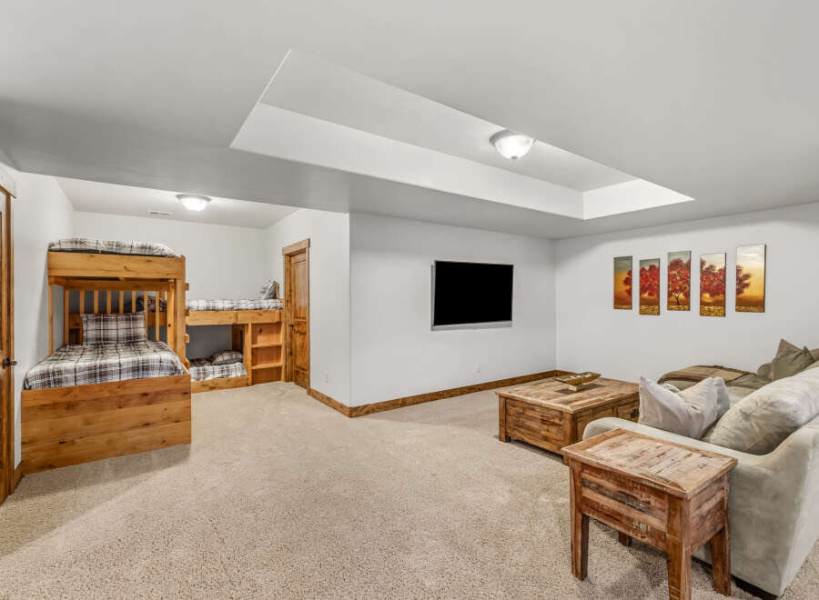 This stunning property features a cozy living space with a comfortable sofa and a stylish coffee table.