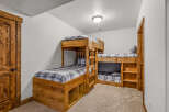 This cozy bedroom features custom-built bunk beds, perfect for a vacation home or a kid's room.