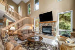 Step into luxury with this stunning living room, featuring a cozy fireplace and a large flat-screen TV, perfect for entertaining.