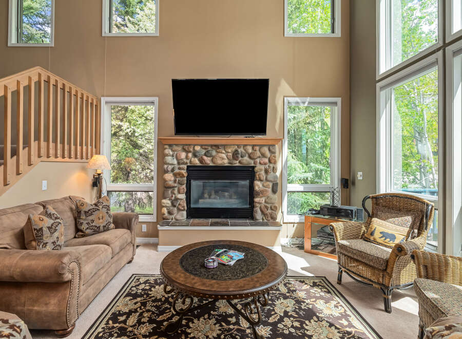 This stunning living room features a cozy fireplace with a stone surround, perfect for those chilly evenings.