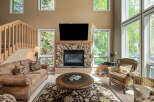 This stunning living room features a cozy fireplace with a stone surround, perfect for those chilly evenings.