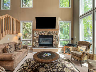 This stunning living room features a cozy fireplace with a stone surround, perfect for those chilly evenings.