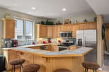 This stunning kitchen boasts a spacious layout with ample counter space and cabinetry, perfect for culinary enthusiasts.