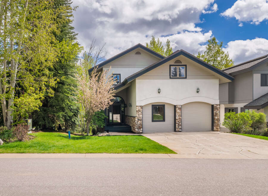 This stunning property boasts a beautiful facade with a combination of stone and stucco, offering a unique curb appeal.