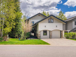 This stunning property boasts a beautiful facade with a combination of stone and stucco, offering a unique curb appeal.