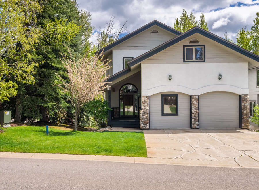 This stunning property boasts a beautiful facade with a combination of stone and stucco.