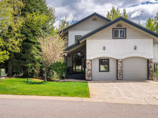 This stunning property boasts a beautiful facade with a combination of stone and stucco.
