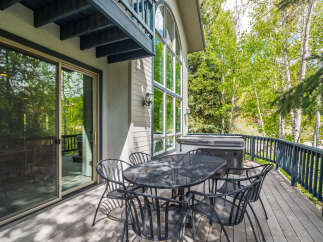 Enjoy the tranquility of this stunning property with a spacious deck, perfect for outdoor gatherings.