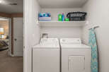 This laundry room features a modern design with a white washer and dryer set.