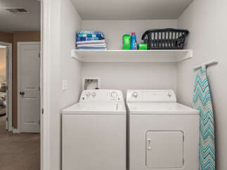 This laundry room features a modern design with a white washer and dryer set.