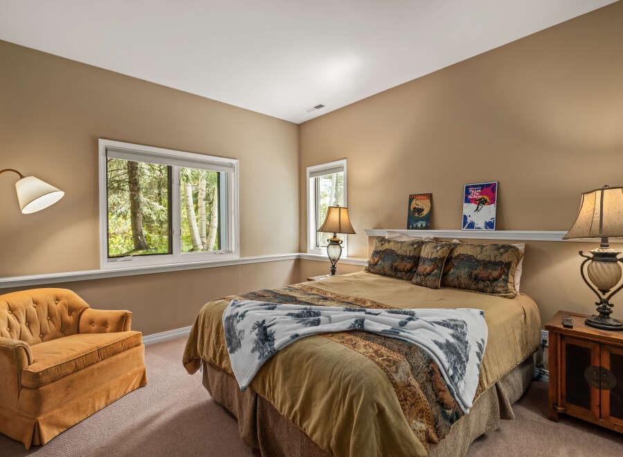 This cozy bedroom features a comfortable bed with decorative pillows and a warm color scheme.