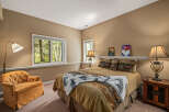 This cozy bedroom features a comfortable bed with decorative pillows and a warm color scheme.