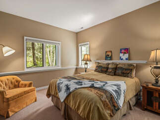 This cozy bedroom features a comfortable bed with decorative pillows and a warm color scheme.