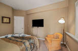 This cozy bedroom features a comfortable bed with a patterned comforter, perfect for relaxation.