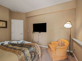 This cozy bedroom features a comfortable bed with a patterned comforter, perfect for relaxation.