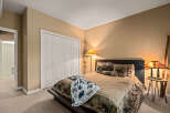 This cozy bedroom features a rustic design with a comfortable bed and warm lighting.