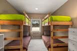 This cozy bedroom features two sets of bunk beds, perfect for accommodating multiple guests or family members.