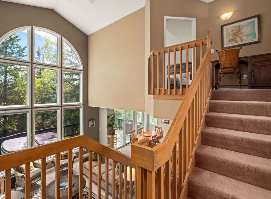 This stunning property boasts a grand staircase leading to a spacious upper level.