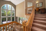 This stunning property boasts a grand staircase leading to a spacious upper level.