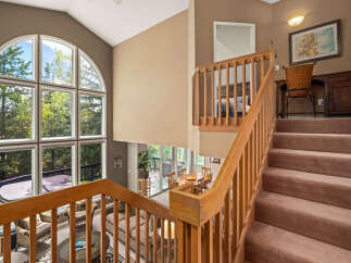 This stunning property boasts a grand staircase leading to a spacious upper level.