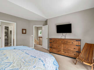 This inviting bedroom features a cozy bed with a stylish patterned comforter, perfect for relaxation.