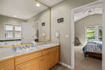 This inviting bathroom features a double vanity with ample counter space and stylish fixtures.