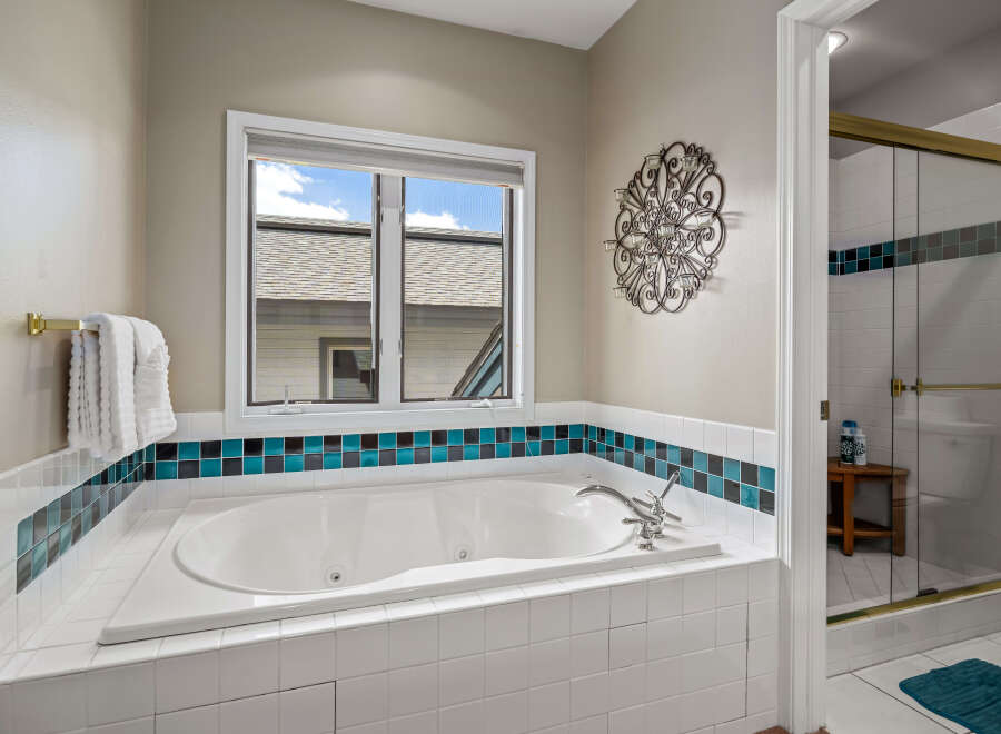 This luxurious bathroom features a spacious jacuzzi tub, perfect for relaxation and unwinding after a long day.