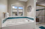 This luxurious bathroom features a spacious jacuzzi tub, perfect for relaxation and unwinding after a long day.