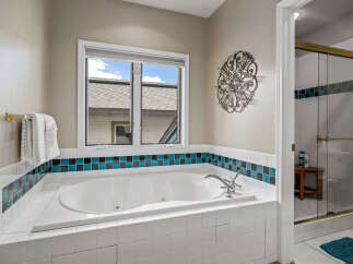 This luxurious bathroom features a spacious jacuzzi tub, perfect for relaxation and unwinding after a long day.