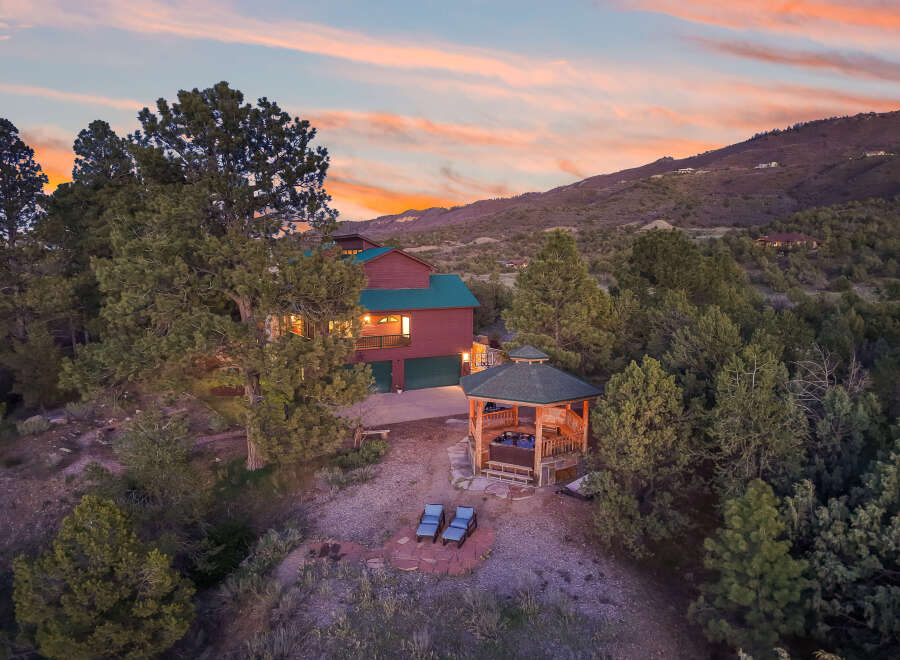 Escape to your dream home nestled in the mountains! This stunning property boasts a luxurious gazebo with a hot tub, perfect for relaxation.