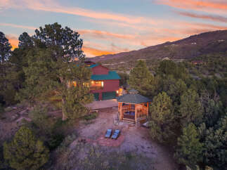 Escape to your dream home nestled in the mountains! This stunning property boasts a luxurious gazebo with a hot tub, perfect for relaxation.