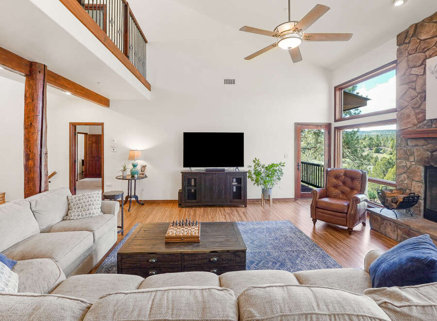 Step into luxury with this stunning living room, featuring a cozy fireplace and a spacious layout perfect for entertaining.