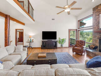 Step into luxury with this stunning living room, featuring a cozy fireplace and a spacious layout perfect for entertaining.