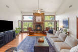 Step into luxury with this stunning living room, featuring a cozy fireplace and expansive windows that frame breathtaking views.