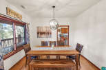 This stunning dining room features a beautiful wooden table and bench, perfect for family gatherings.